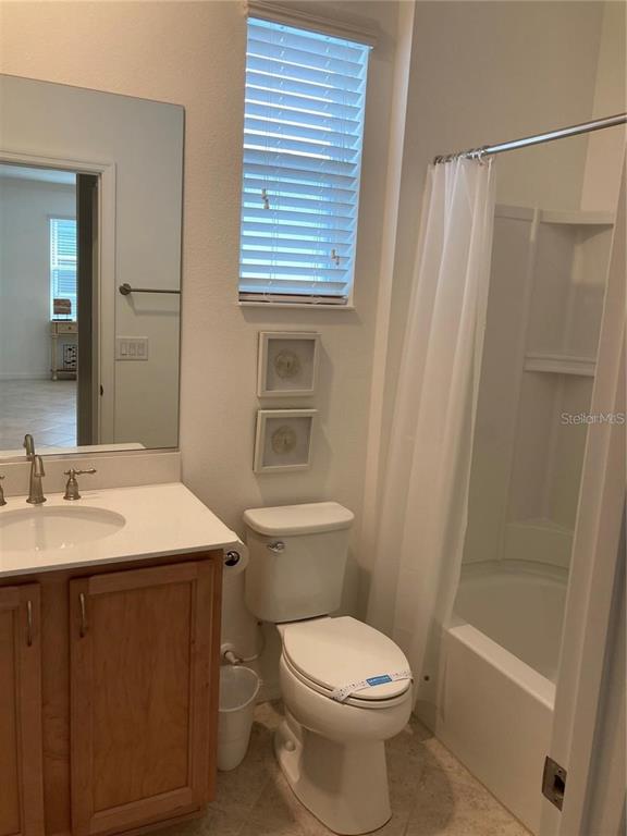 9877 Southwest 99th Loop Ocala, FL 34481 - Photo 5 of 10 a bathroom with a sink a toilet and shower