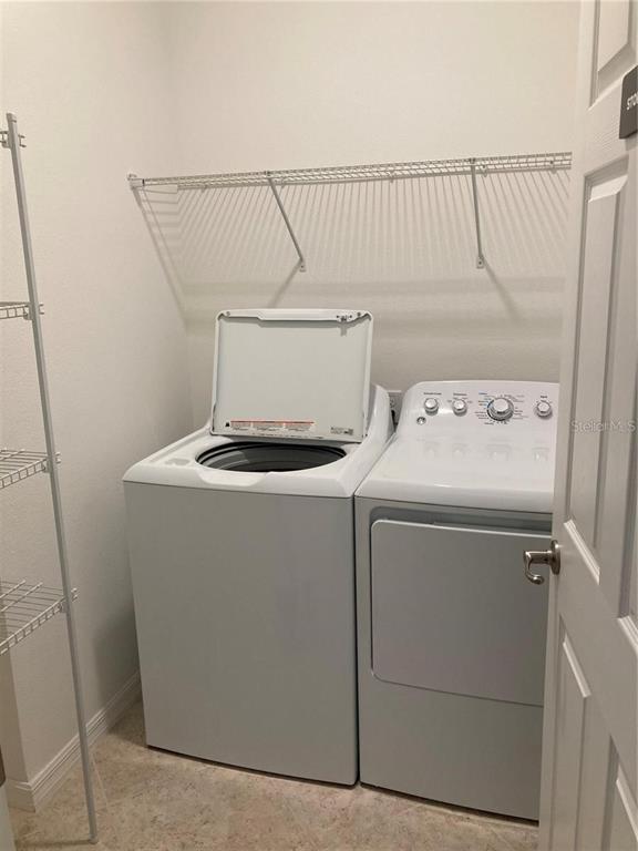 9877 Southwest 99th Loop Ocala, FL 34481 - Photo 6 of 10 a utility room with dryer and washer