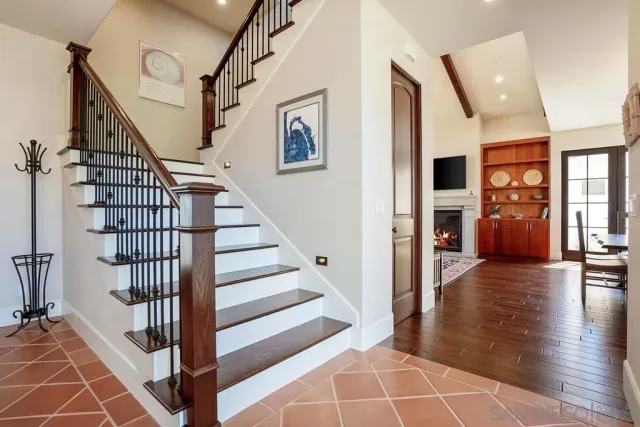 a large kitchen with stainless steel appliances kitchen island wooden floors and a large window