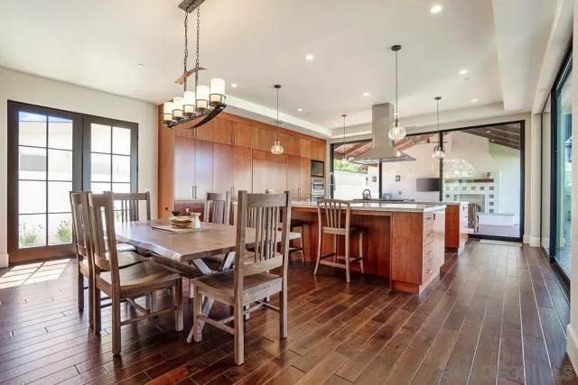 a kitchen with stainless steel appliances kitchen island granite countertop a stove top oven a sink and a refrigerator