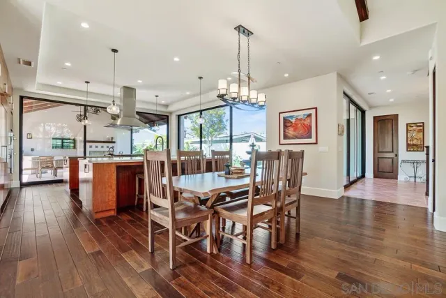 a large kitchen with stainless steel appliances kitchen island granite countertop a stove a sink and a refrigerator