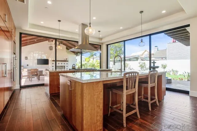 a view of a dining room with furniture a chandelier and wooden floor