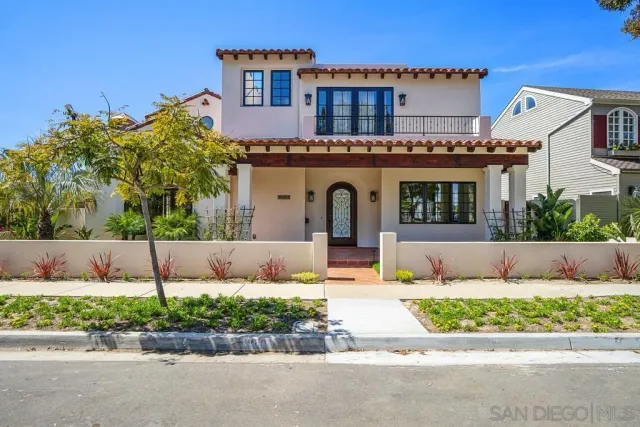 a front view of a house with a garden and plants