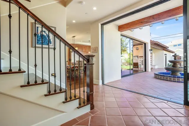 a bathroom with a double vanity sink a toilet a mirror and shower