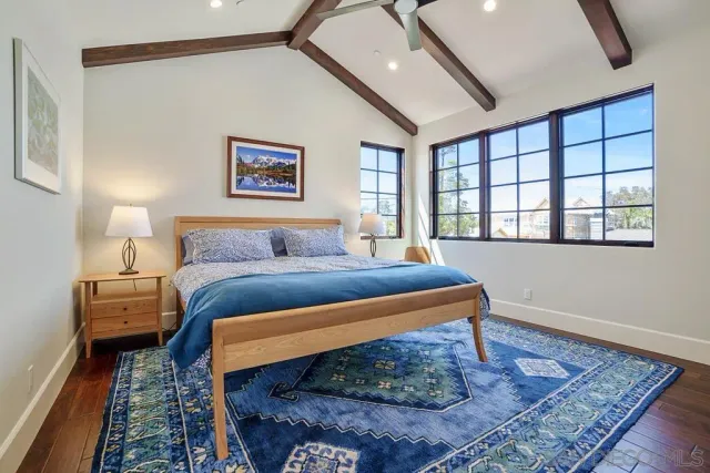 a view of a hallway with wooden floor and dining room