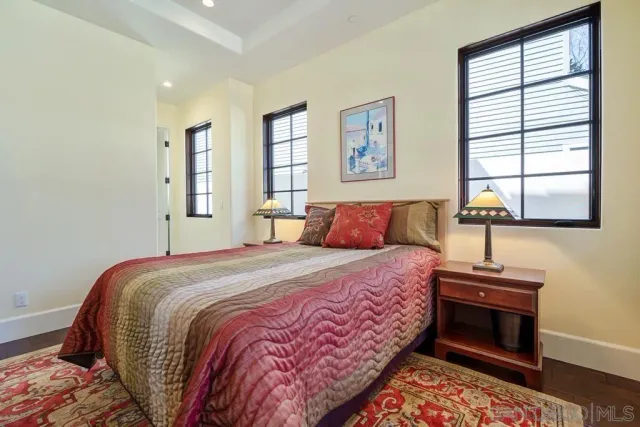 a bathroom with a granite countertop shower mirror and a toilet