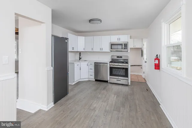a kitchen with a stove and a refrigerator