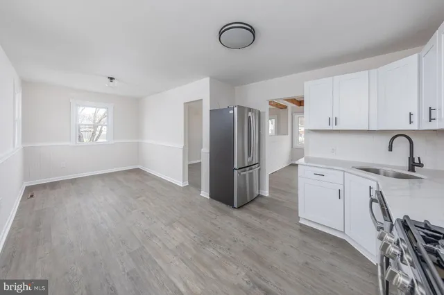 a kitchen with stainless steel appliances a refrigerator sink and cabinets