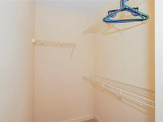 a view of a house with a big yard and large trees