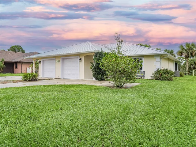 a kitchen with a sink a stove and white cabinets
