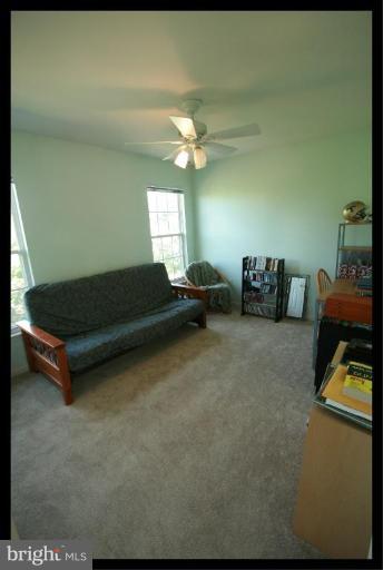 726 Monarch Ridge Road Frederick, MD 21703 - Photo 5 of 12 a living room with furniture and a chandelier