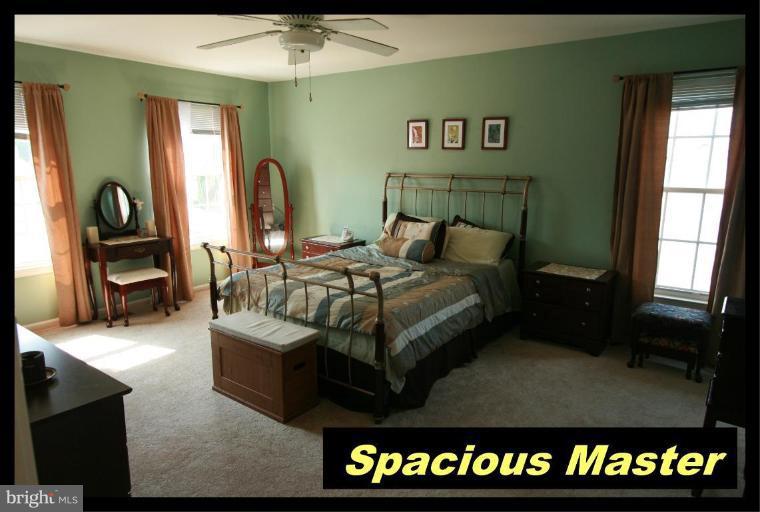 726 Monarch Ridge Road Frederick, MD 21703 - Photo 10 of 12 a bedroom with a bed and a mirror