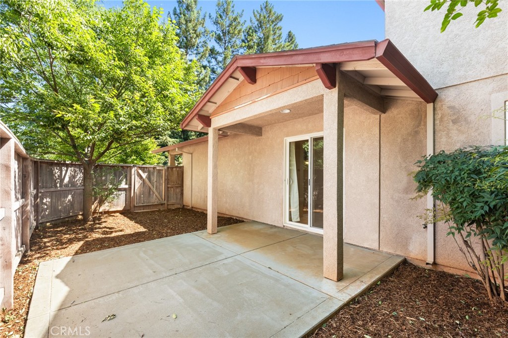38 Kobe Loop Chico, CA 95973 - Photo 19 of 38 a backyard of a house with potted plants and large tree