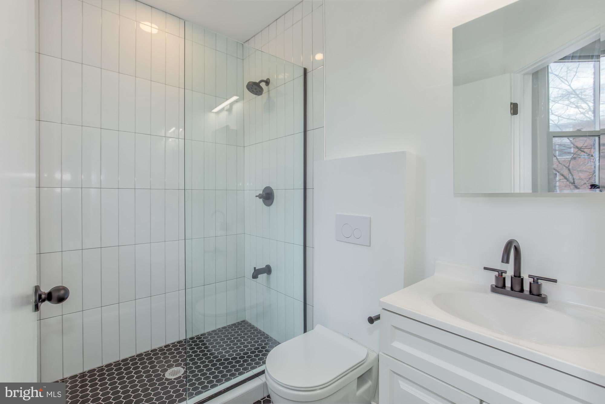 745 Kenyon Street Northwest Washington, DC 20010 - Photo 14 of 27 a bathroom with a sink a toilet and shower