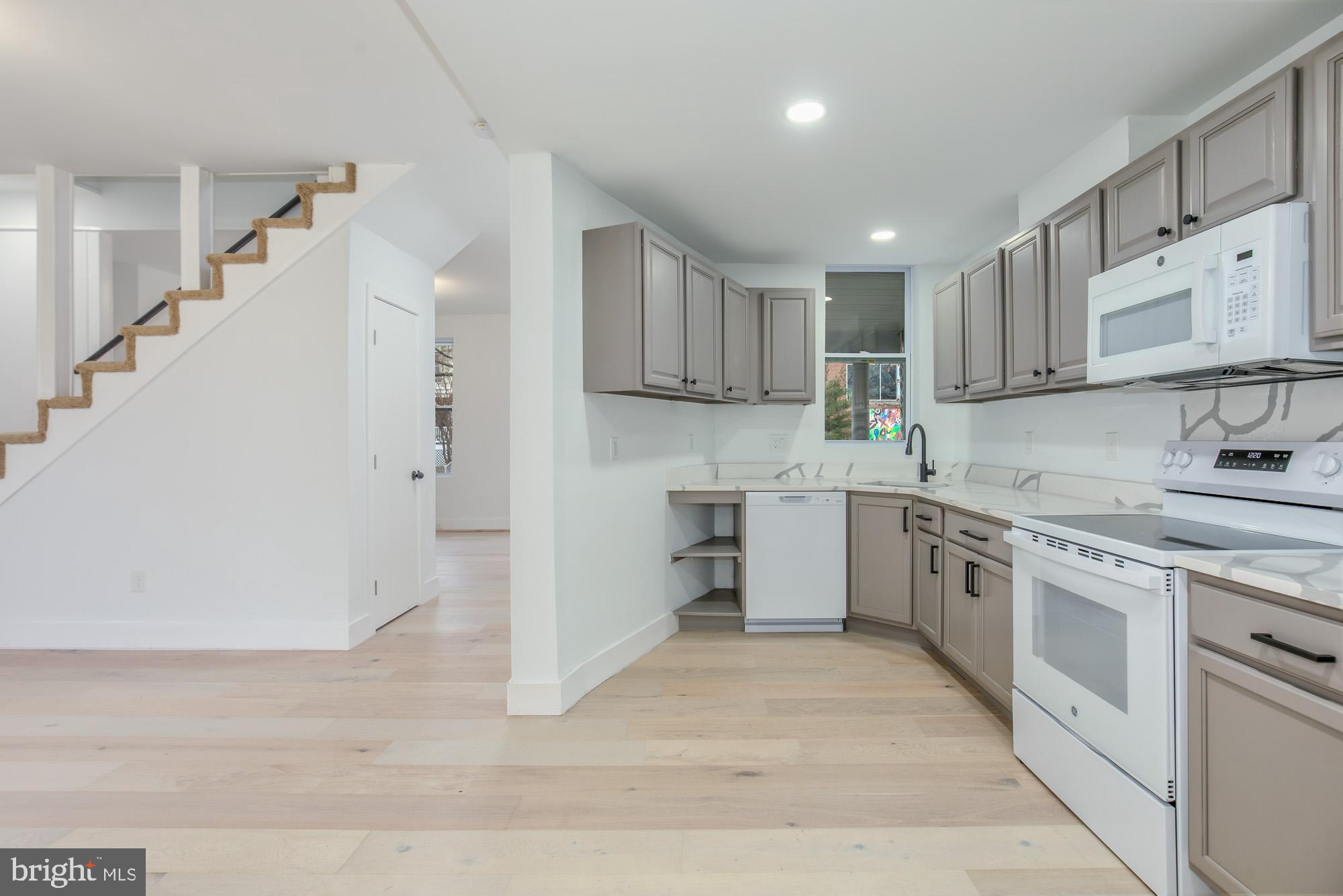 745 Kenyon Street Northwest Washington, DC 20010 - Photo 9 of 27 a kitchen with cabinets and window