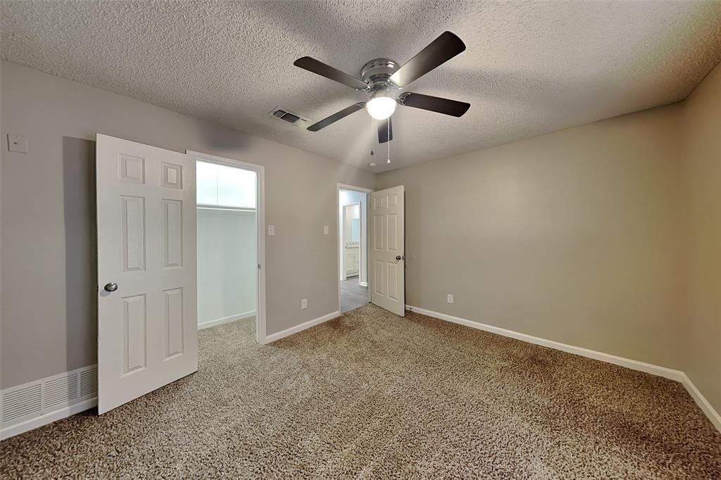 3817 Rochelle Drive Arlington, TX 76016 - Photo 14 of 25 an empty room with closet and windows