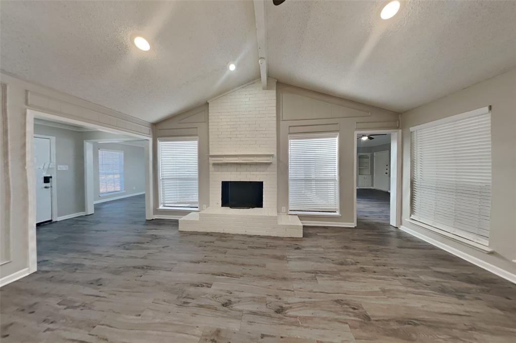 3817 Rochelle Drive Arlington, TX 76016 - Photo 3 of 25 a view of an empty room with a fireplace and a window