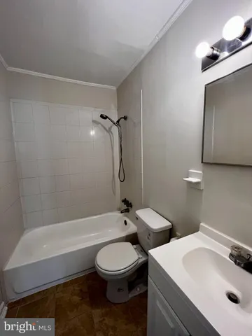 a bathroom with a toilet sink and shower