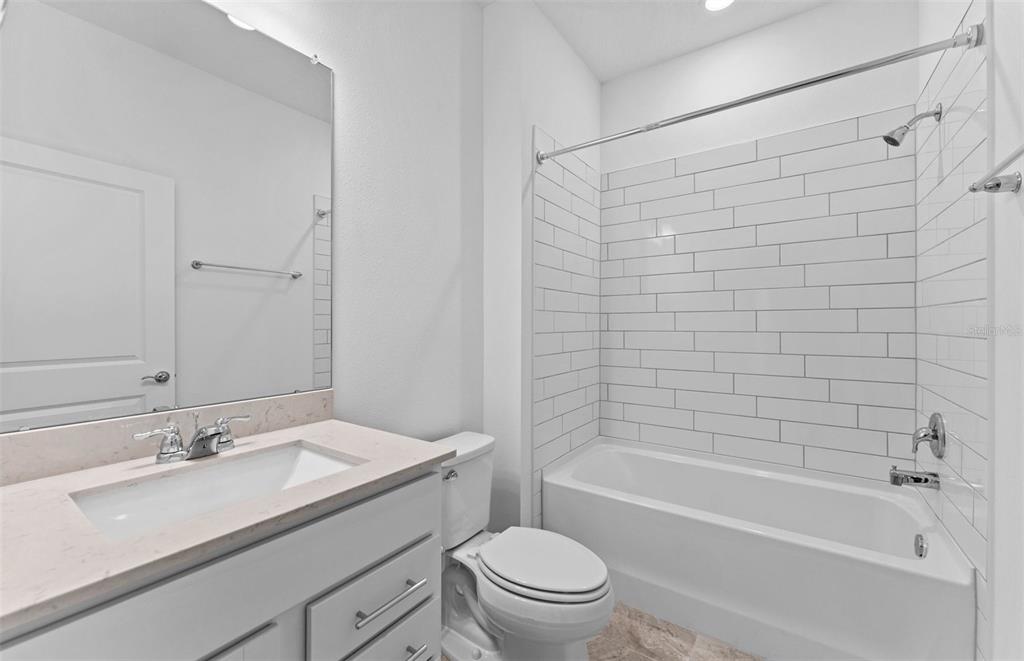 4147 Feldspar Lane Spring Hill, FL 34609 - Photo 12 of 22 a bathroom with a sink toilet and shower