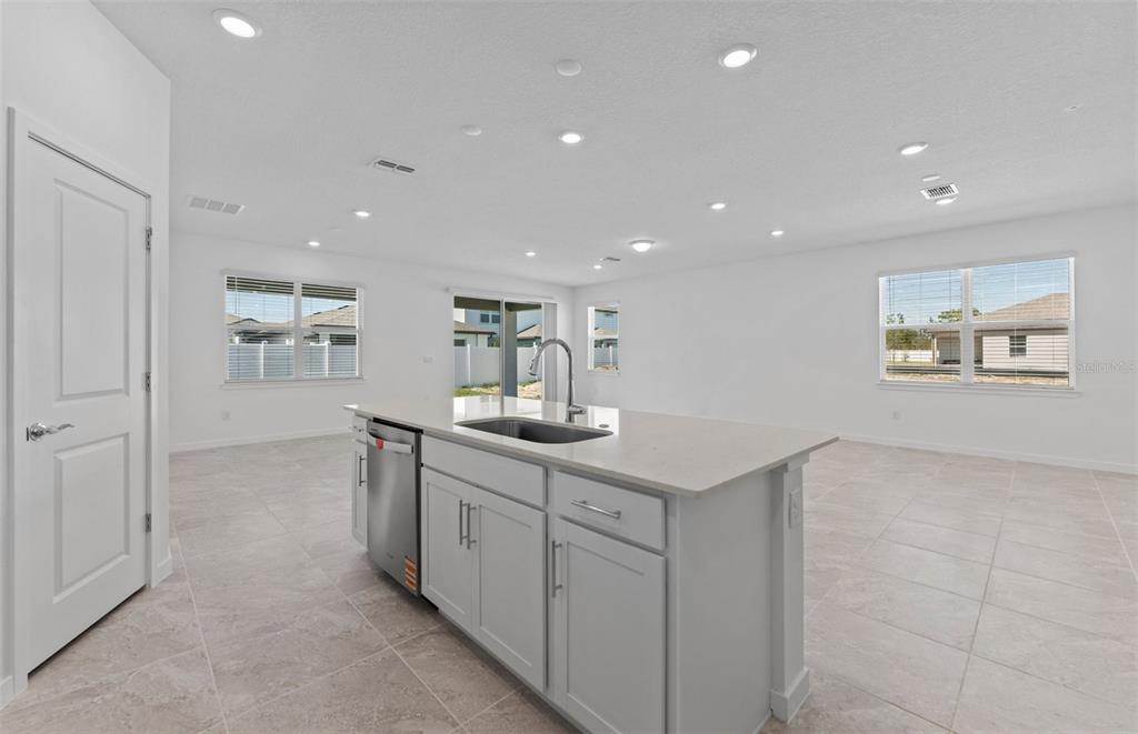 4147 Feldspar Lane Spring Hill, FL 34609 - Photo 4 of 22 a kitchen with white cabinets and sink