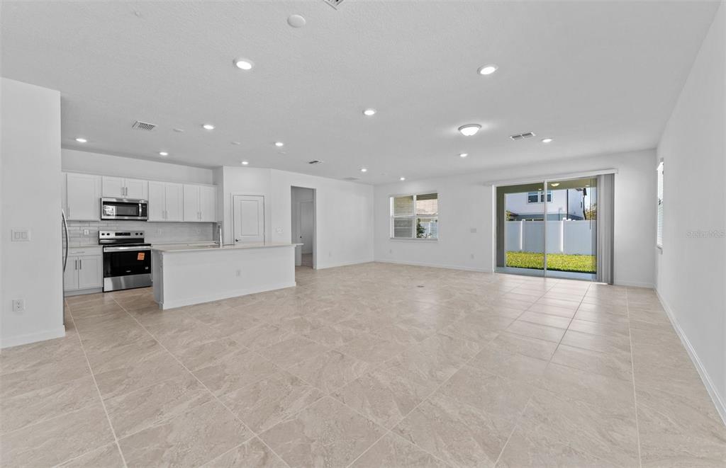 4147 Feldspar Lane Spring Hill, FL 34609 - Photo 7 of 22 a view of an empty room with a kitchen