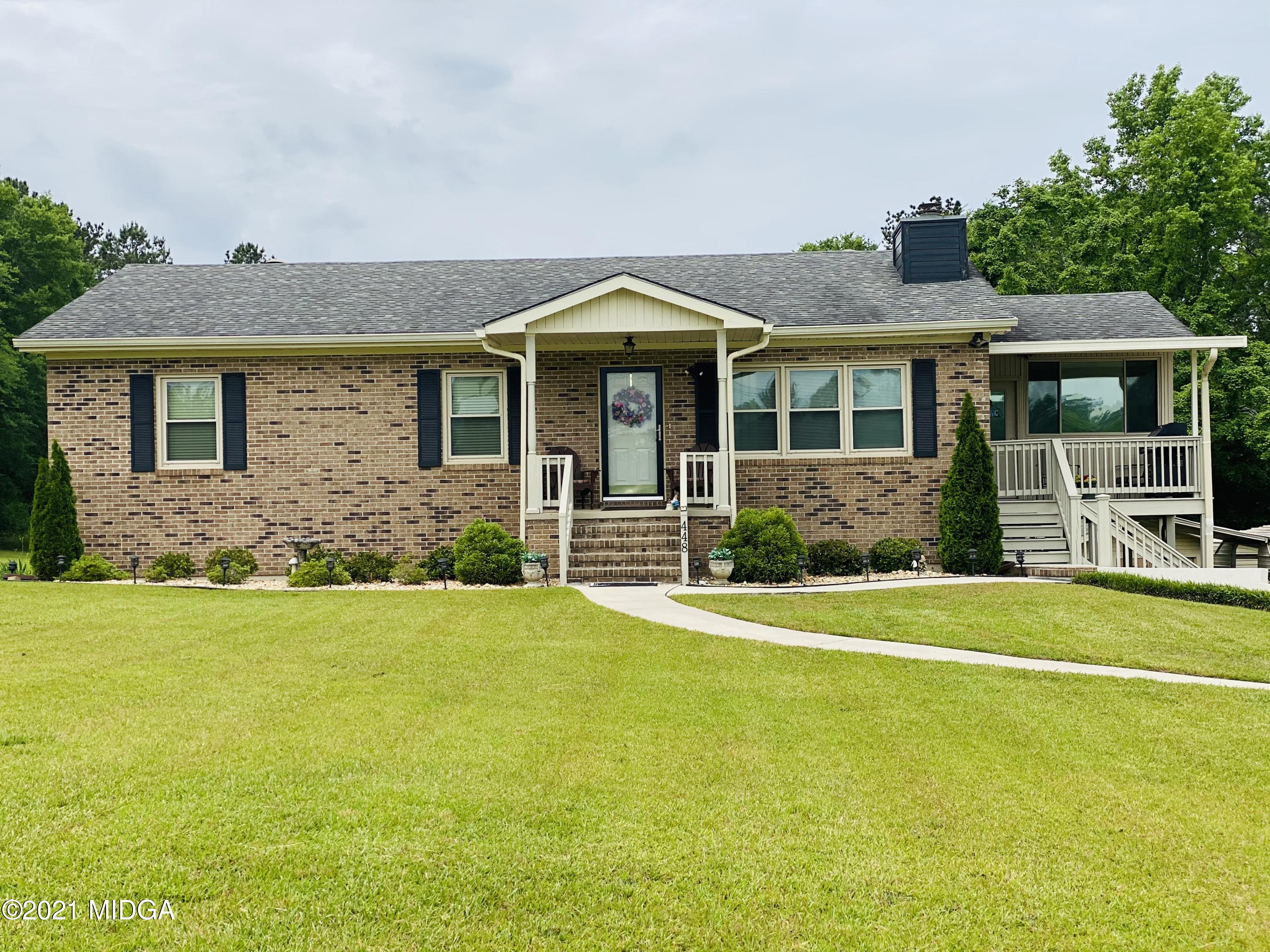 a front view of a house with a garden