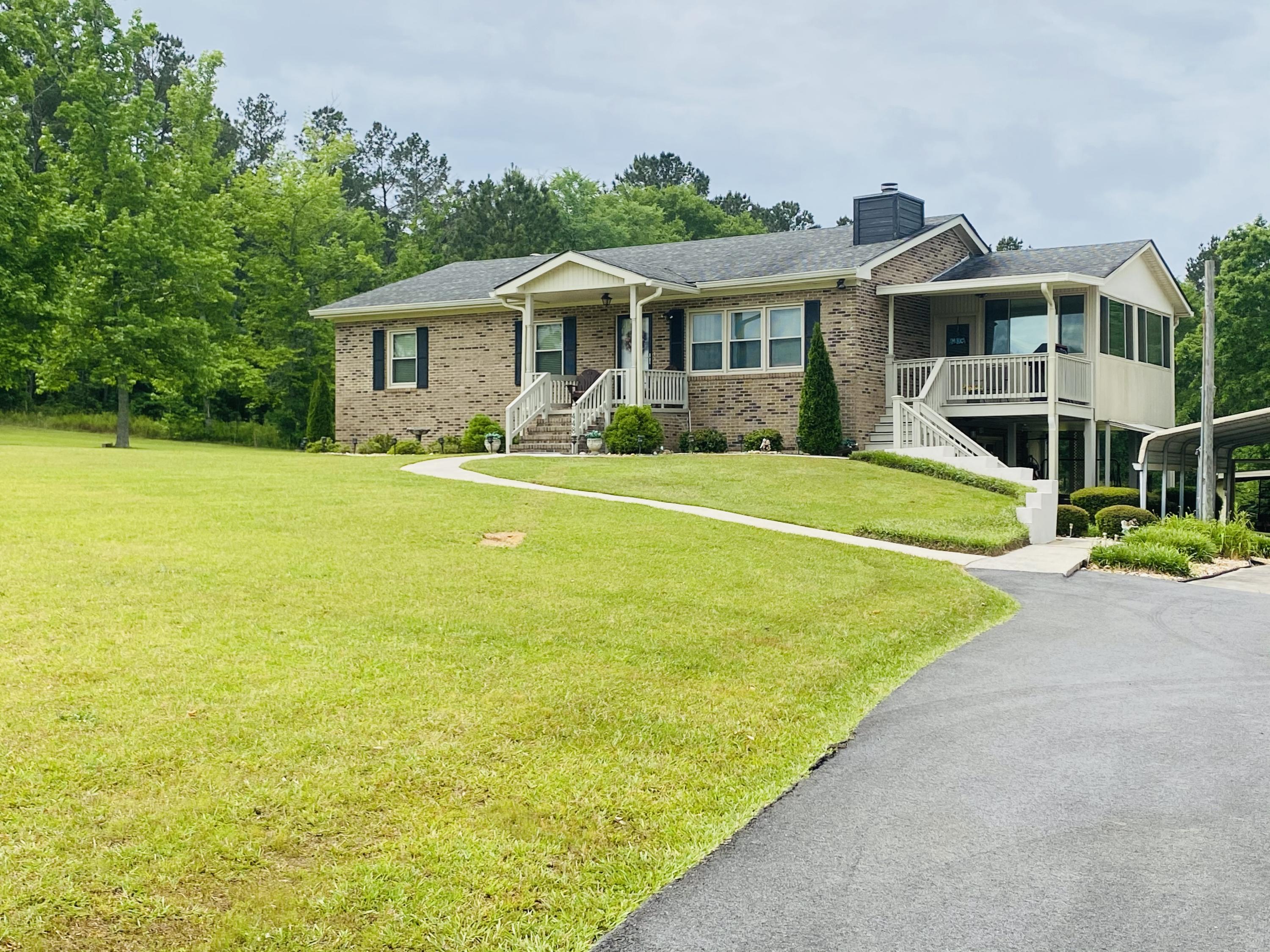 448 Huckabee Road Gray, GA 31032 - Photo 2 of 13 a front view of a house with swimming pool having outdoor seating