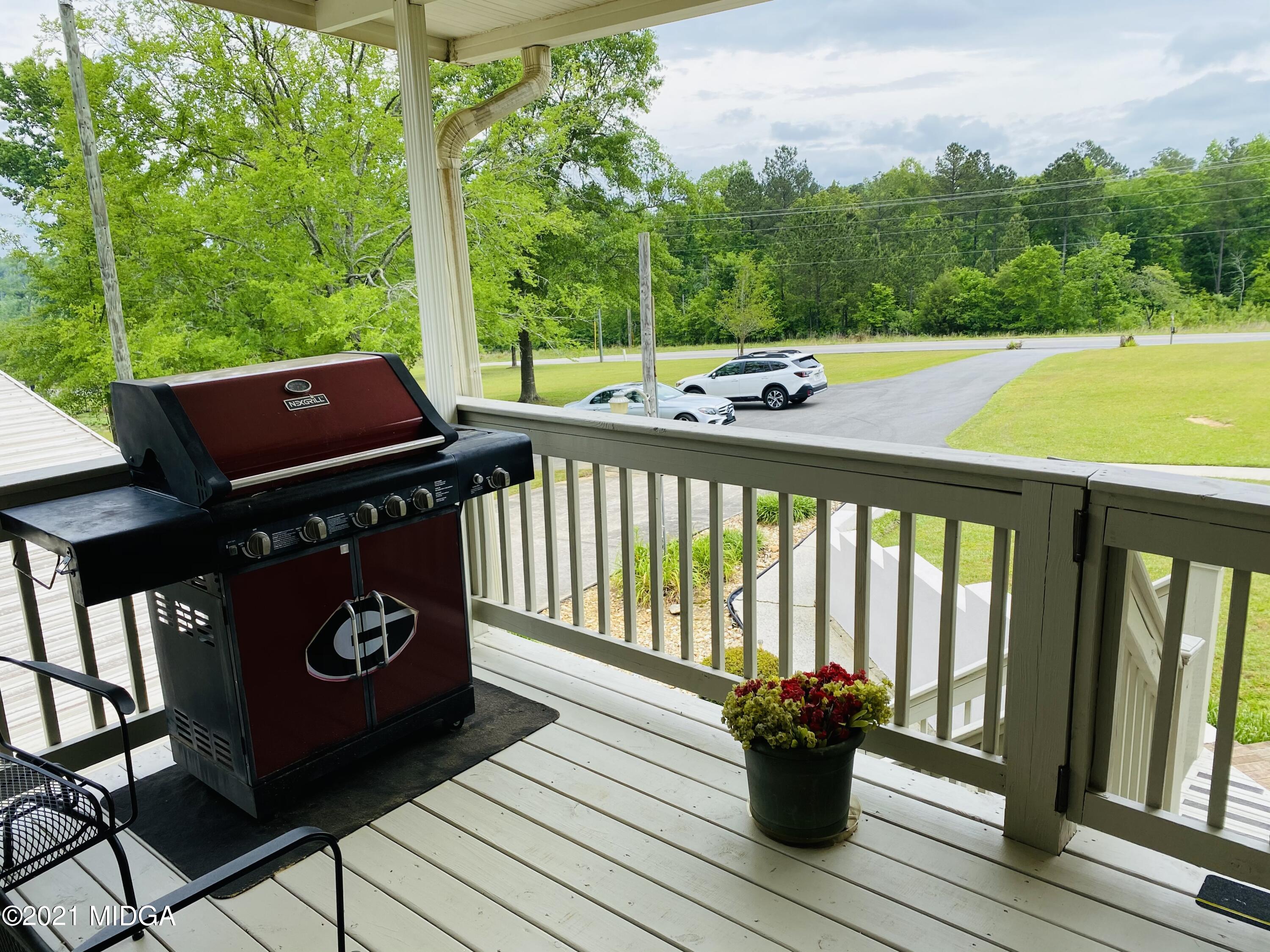 448 Huckabee Road Gray, GA 31032 - Photo 13 of 13 a view of a two chairs and table on the wooden deck