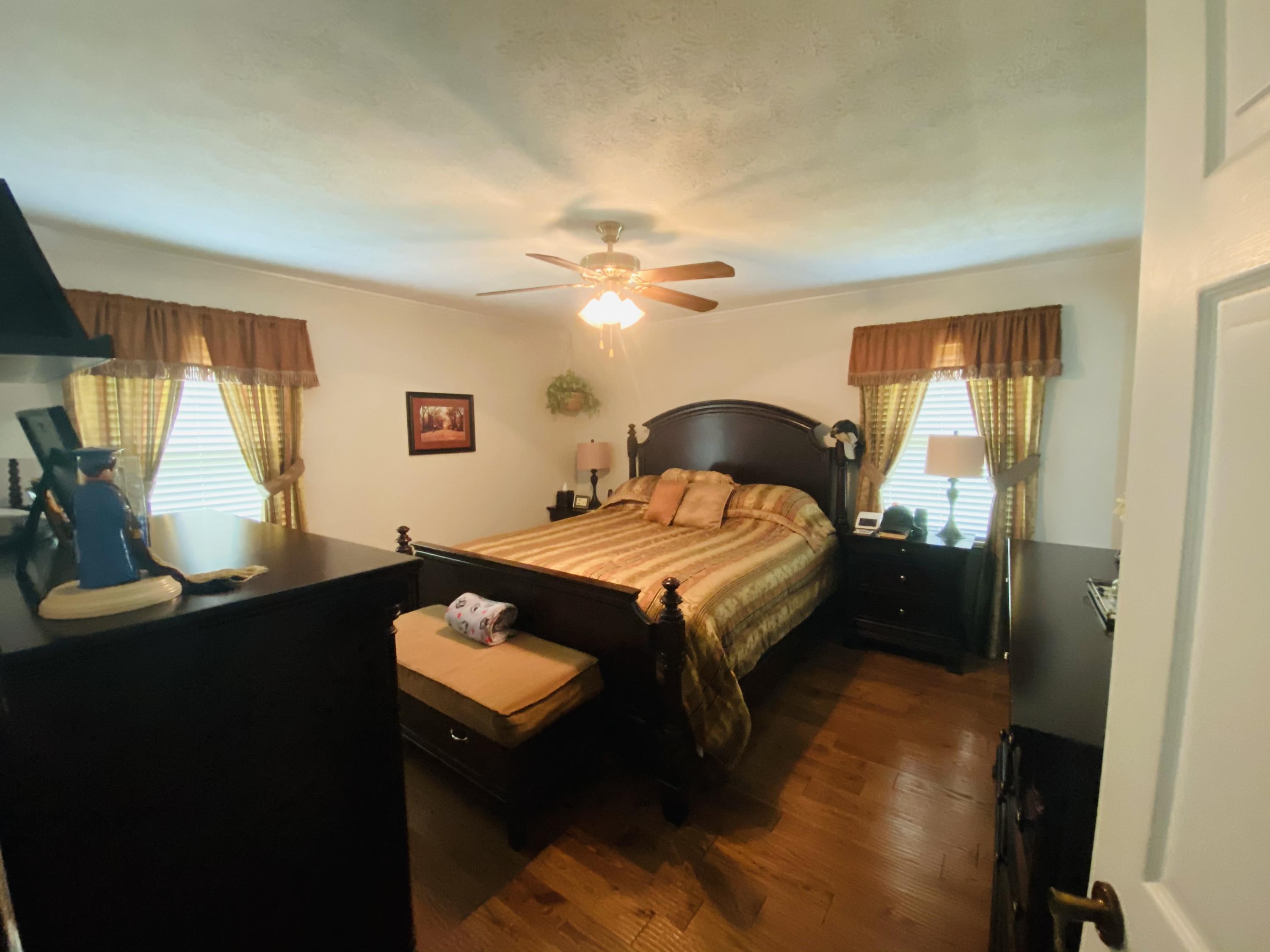 448 Huckabee Road Gray, GA 31032 - Photo 3 of 13 a bedroom with a bed and a chandelier