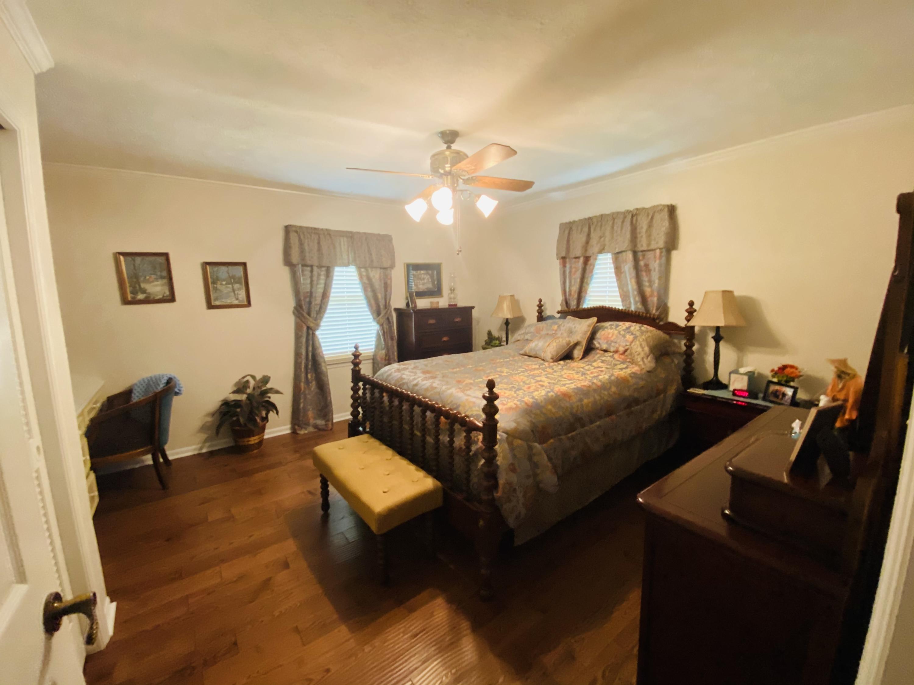 448 Huckabee Road Gray, GA 31032 - Photo 4 of 13 a bedroom with a bed and wooden floor