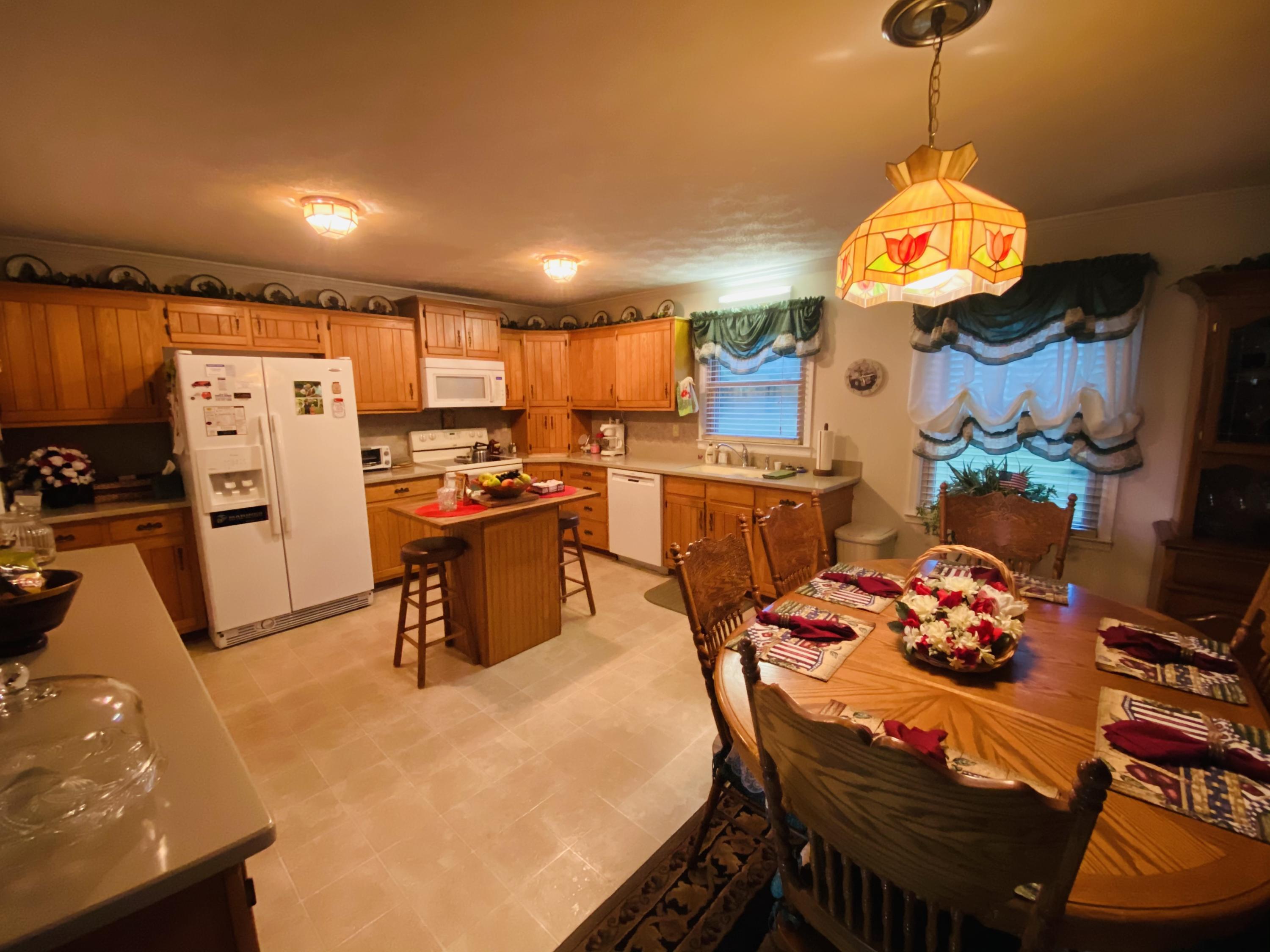 448 Huckabee Road Gray, GA 31032 - Photo 7 of 13 a kitchen with stainless steel appliances granite countertop a sink a stove and a refrigerator