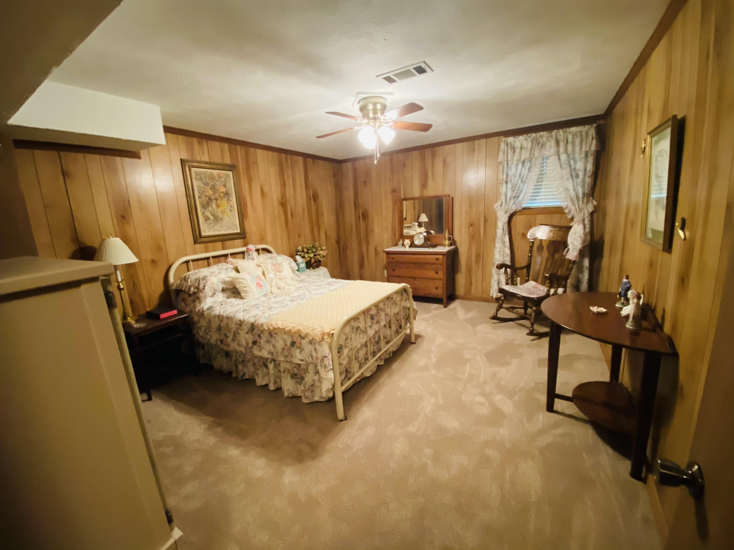 448 Huckabee Road Gray, GA 31032 - Photo 8 of 13 a bedroom with a bed dresser and a large mirror