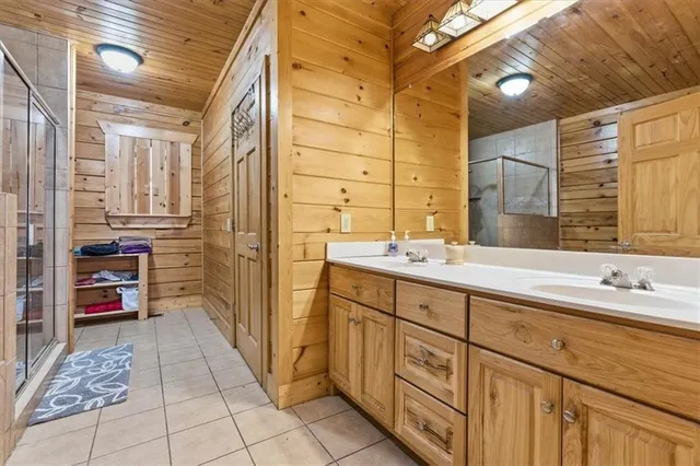 a bathroom with a double vanity sink and a mirror