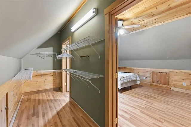 a view of a bedroom with wooden floor