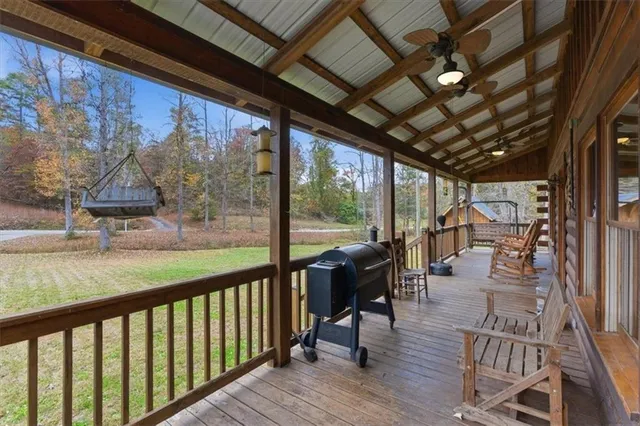 a view of a balcony with chairs and wooden floor