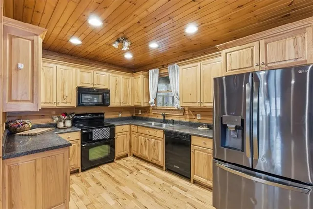 a kitchen with granite countertop stainless steel appliances and wooden cabinets