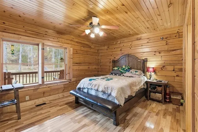 a spacious bedroom with a bed and a chandelier