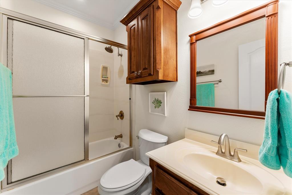 345 Rains County Road 3390 Emory, TX 75440 - Photo 31 of 39 a bathroom with a sink a mirror toilet and shower