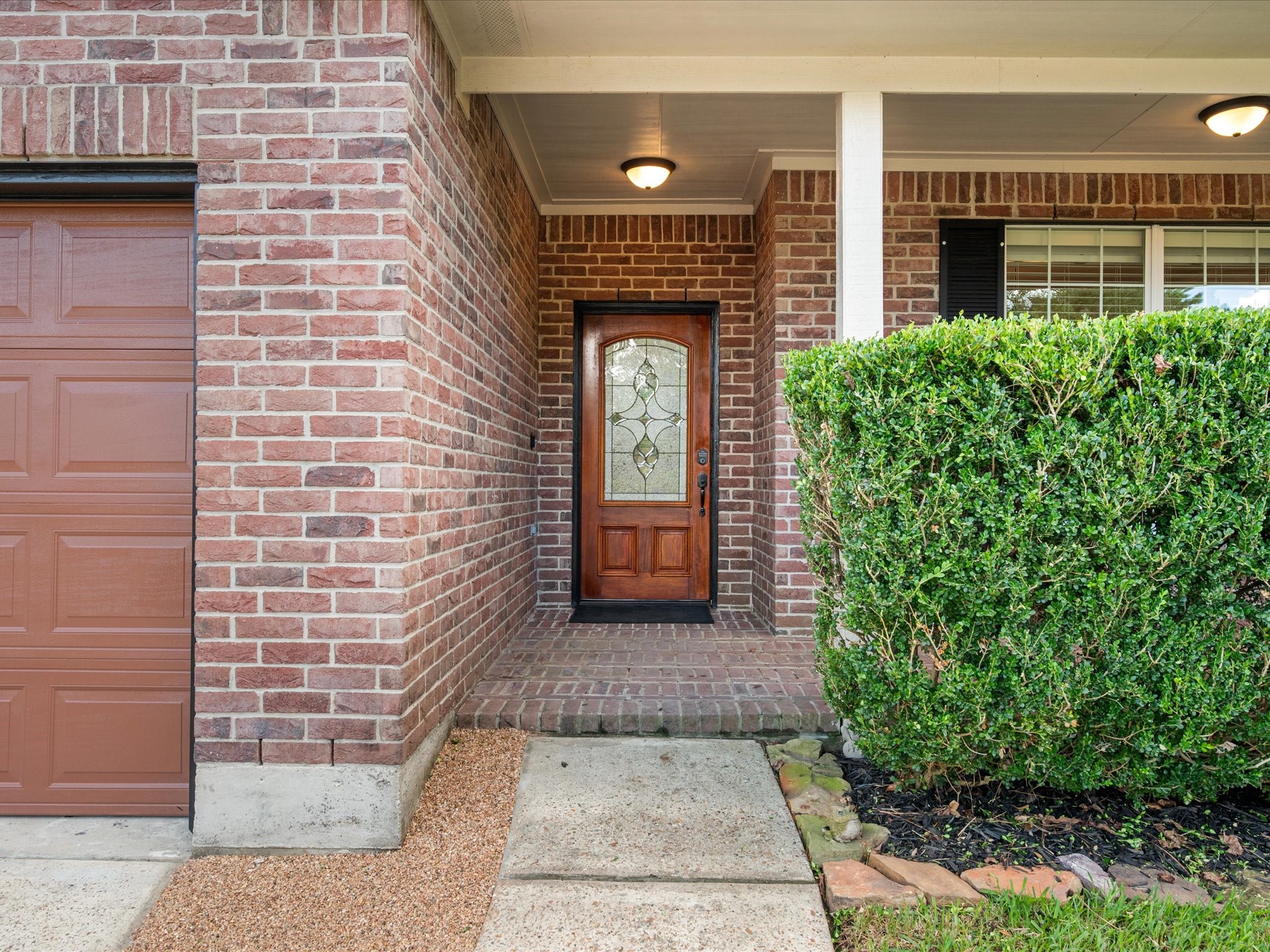 291 Sunset Path South Conroe, TX 77316 - Photo 6 of 39 A beautiful brick facade welcomes you home, complemented by a charming front patio that creates an inviting first impression.