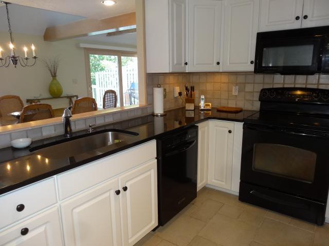 258 Huckins Neck Road Centerville, MA 02601 - Photo 11 of 30 a kitchen with granite countertop a sink stainless steel appliances and cabinets