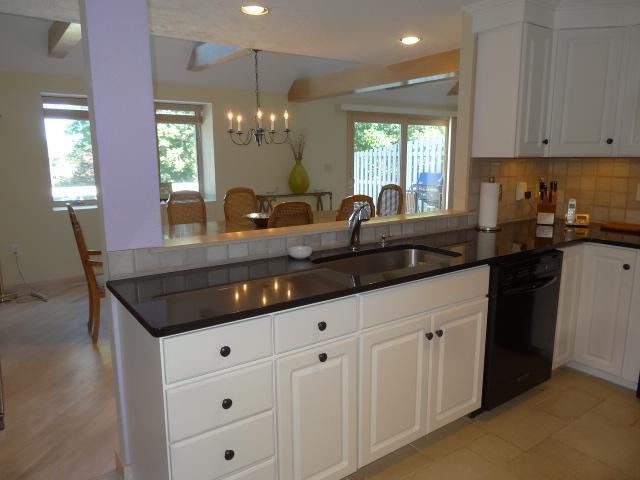 258 Huckins Neck Road Centerville, MA 02601 - Photo 12 of 30 a kitchen with granite countertop a sink and cabinets