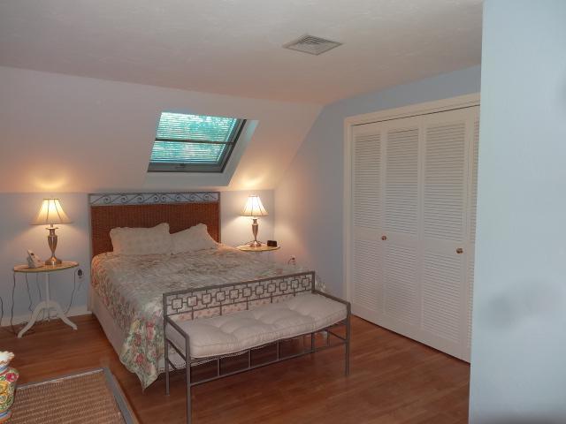 258 Huckins Neck Road Centerville, MA 02601 - Photo 20 of 30 a bedroom with a bed and a lamp