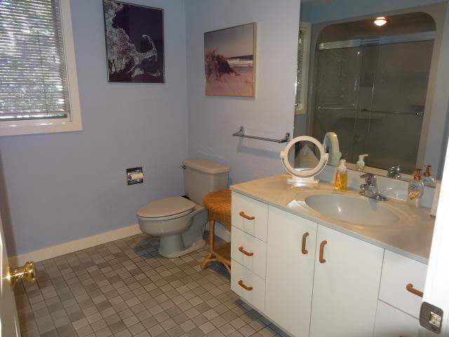 258 Huckins Neck Road Centerville, MA 02601 - Photo 21 of 30 a bathroom with a sink a toilet and a mirror