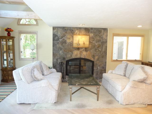 258 Huckins Neck Road Centerville, MA 02601 - Photo 6 of 30 a living room with furniture and a fireplace
