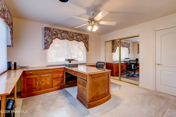 a living room with furniture a fireplace and a floor to ceiling window