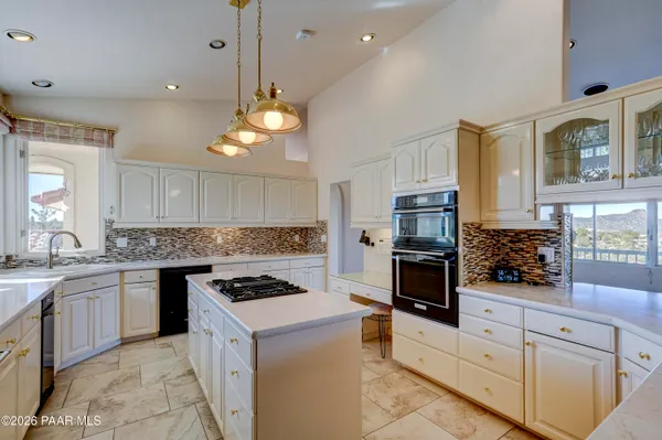 a kitchen with stainless steel appliances granite countertop a stove and a sink