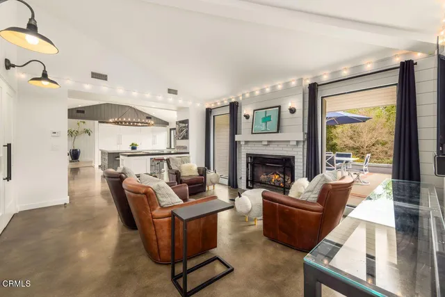 a living room with furniture fireplace and a flat screen tv