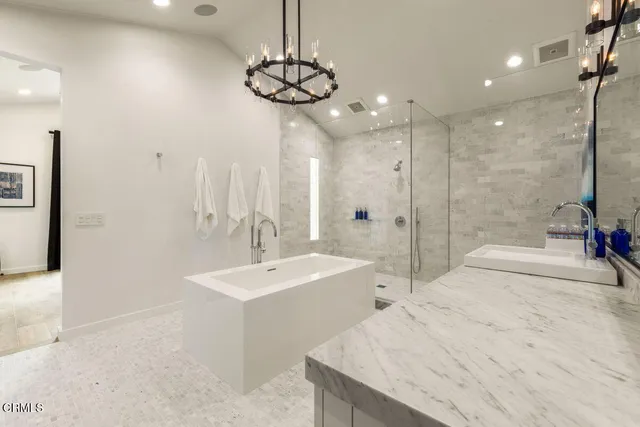 a bathroom with a tub sink and mirror