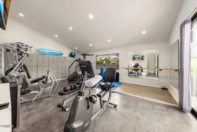 a bathroom with a granite countertop sink and a large mirror