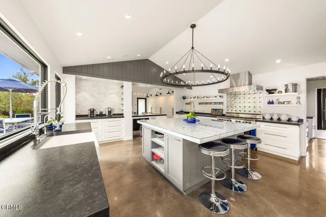 a kitchen with stainless steel appliances granite countertop a stove and a sink